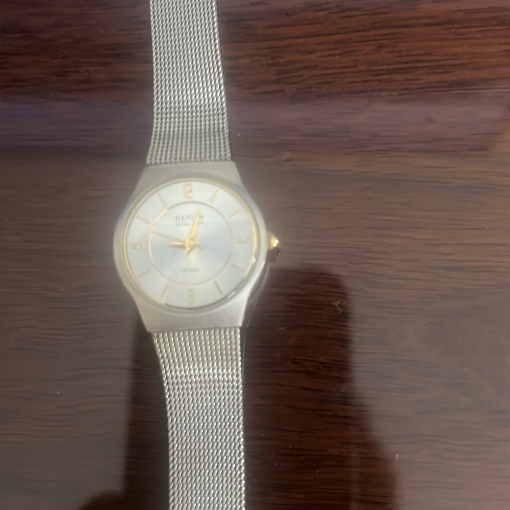 Beautiful slim line watch with white face and gold times. Dressy or everyday